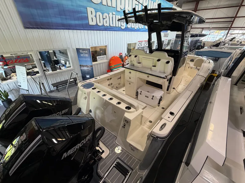 Slide: The Image of Scout 260 LXF 2027 in a showroom with twin Mercury engines. - 44