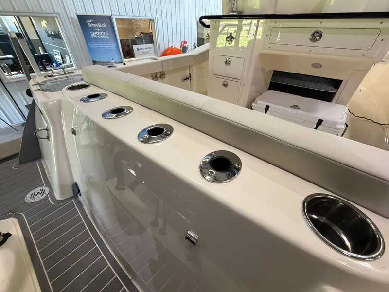 Slide: The Image of The image shows the deck of a Scout 260 LXF boat with multiple cup holders. - 23