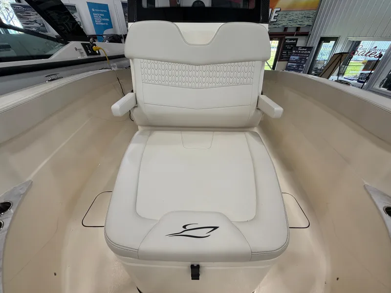 Slide: The Image of The image shows the seating area of a 2027 Scout 260 LXF boat with white upholstery. - 46