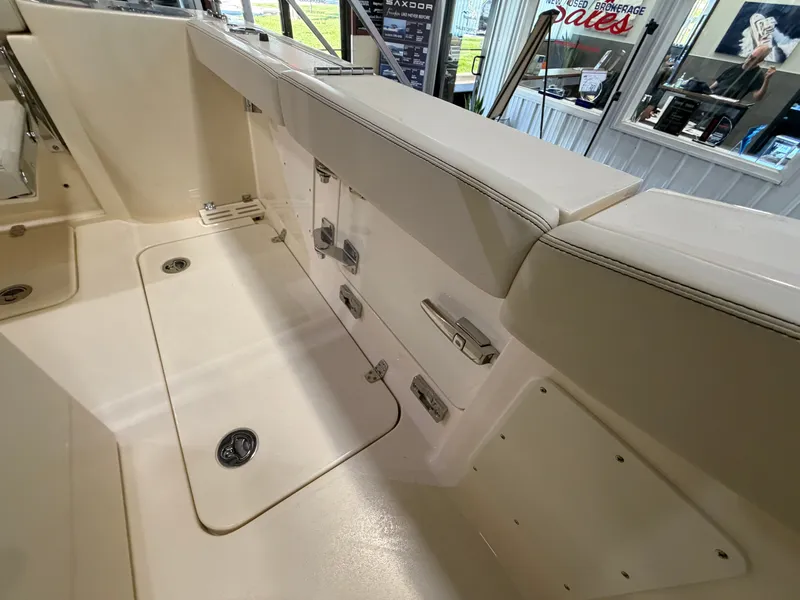 Slide: The Image of The image shows the cockpit of a Scout 260 LXF boat with storage and seating areas. - 38