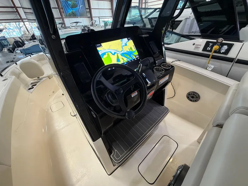 Slide: The Image of The image shows the cockpit of a 2027 Scout 260 LXF boat with a modern navigation system. - 20