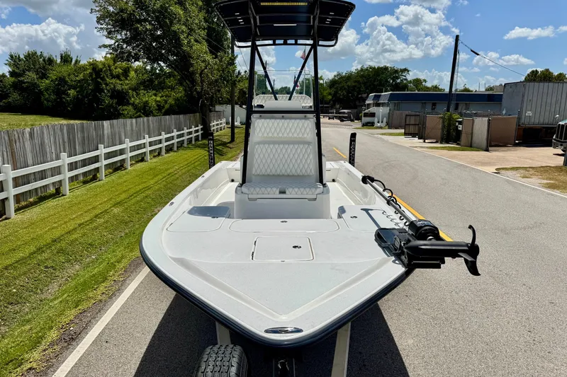 Slide: The Image of 2025 Shallow Sport 24 Modified V boat on a sunny street, showcasing sleek design. - 6