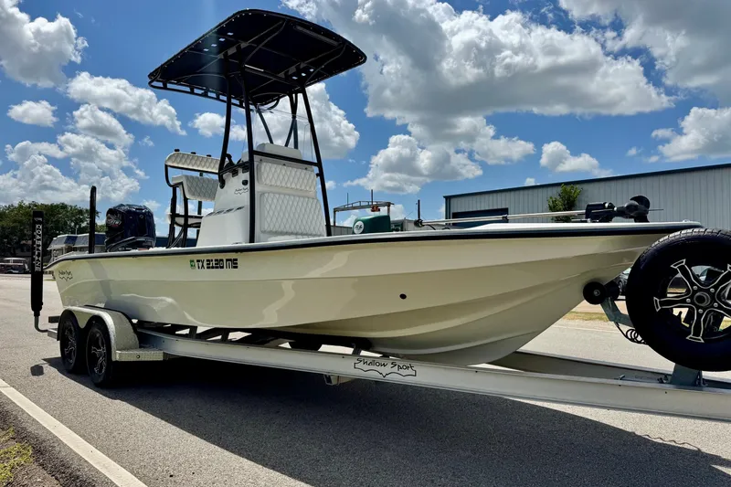 Slide: The Image of 2025 Shallow Sport 24 Modified V boat on trailer under a cloudy sky. - 5