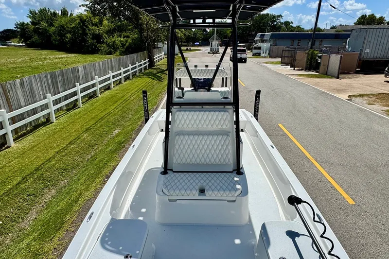 Slide: The Image of 2025 Shallow Sport 24 Modified V boat on a road, showcasing interior seating and design. - 15