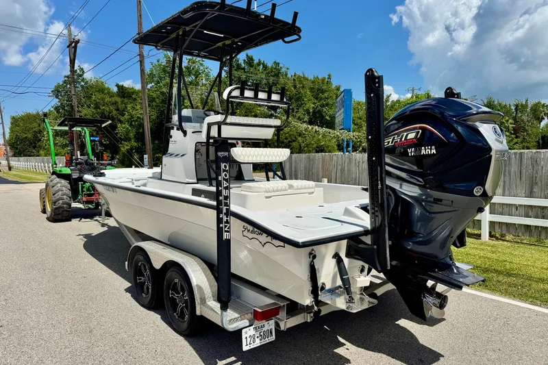 Slide: The Image of 2025 Shallow Sport 24 Modified V boat with Yamaha engine on trailer. - 2