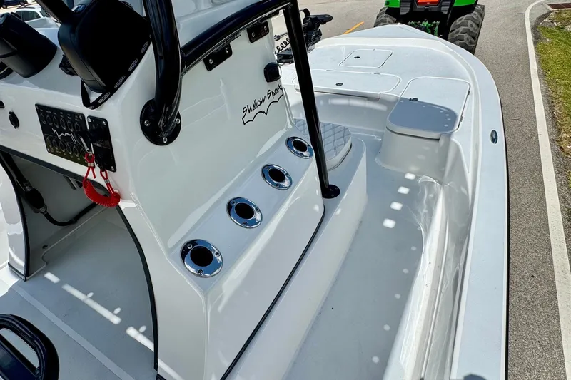 Slide: The Image of 2025 Shallow Sport 24 Modified V boat interior with control panel and rod holders. - 14