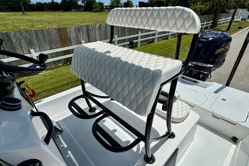 Slide: The Image of 2025 Shallow Sport 24 Modified V boat with white diamond-stitched seating and black frame. - 9