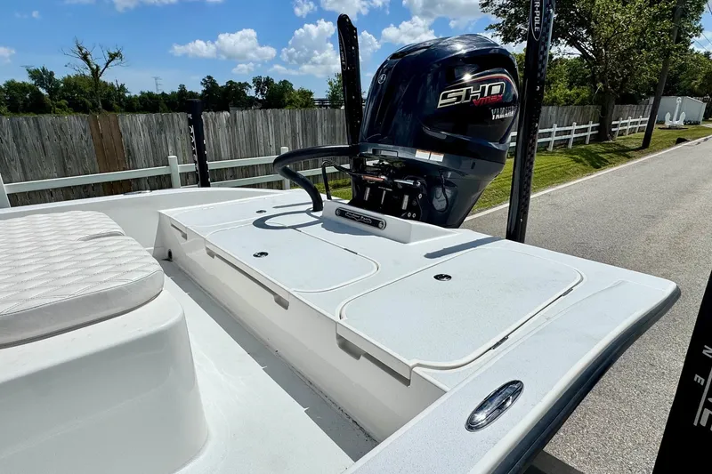 Slide: The Image of 2025 Shallow Sport 24 Modified V boat with Yamaha engine, parked on a sunny day. - 7