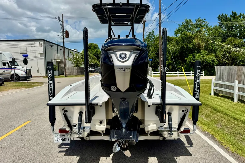 Slide: The Image of 2025 Shallow Sport 24 Modified V boat with powerful outboard motor on a sunny street. - 3