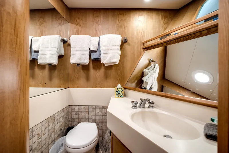 Slide: The Image of Luxurious bathroom with wood paneling, sink, and towels on the wall. - 48