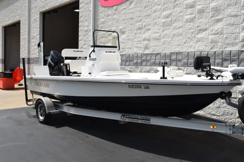 Slide: The Image of 2023 Blazer Bay 2020 boat on trailer outside a building. - 2