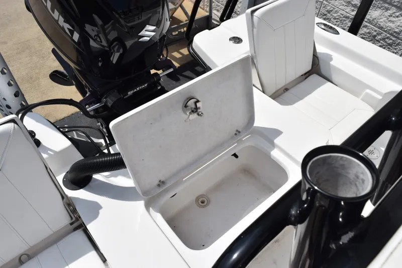 Slide: The Image of Blazer Bay 2020 boat interior with open storage compartment and Suzuki outboard motor, 2023 model. - 11