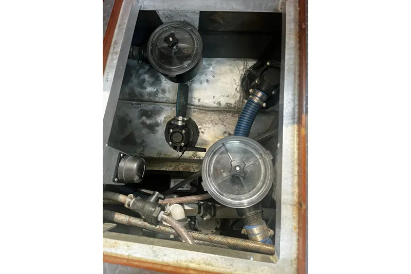 Slide: The Image of Engine compartment of a 2005 Brewer Cutter with visible hoses and components. - 18