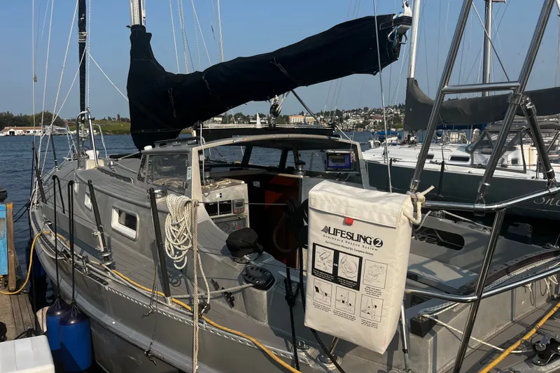 Slide: The Image of Sailboat docked at marina, featuring a 2005 Brewer Cutter with Lifesling safety equipment. - 30