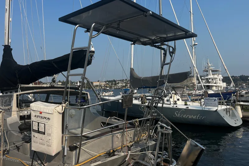 Slide: The Image of Sailboats docked at marina, featuring a 2005 Brewer Cutter. - 32