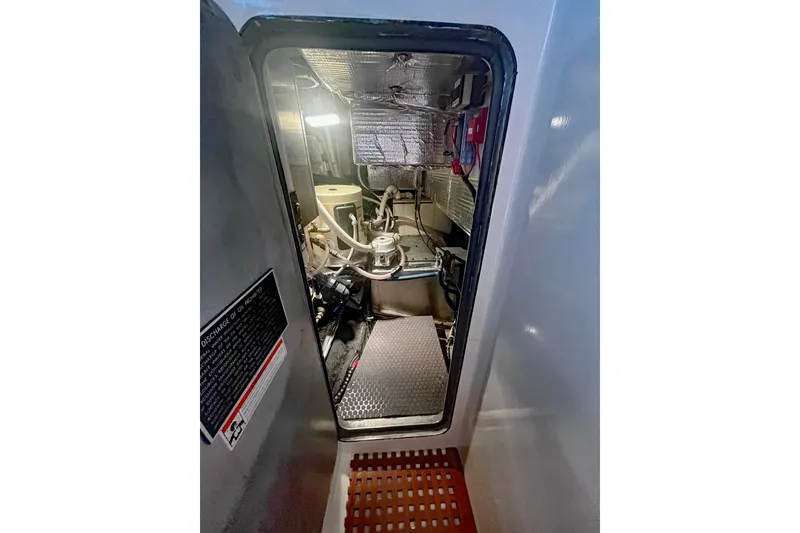 Slide: The Image of Engine room of a 2005 Brewer Cutter boat, featuring machinery and equipment. - 15