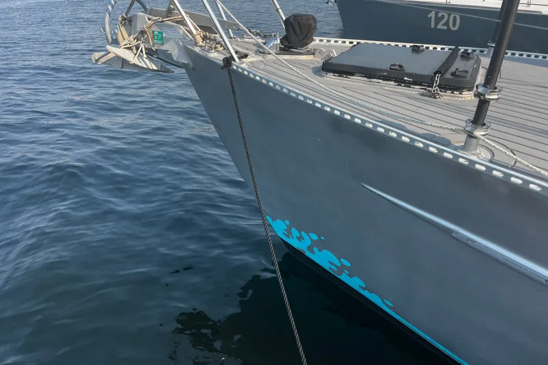 Slide: The Image of Bow of a 2005 Brewer Cutter boat docked on calm water. - 28