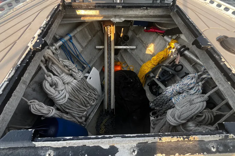 Slide: The Image of Open storage compartment on a 2005 Brewer Cutter boat, filled with ropes and equipment. - 40
