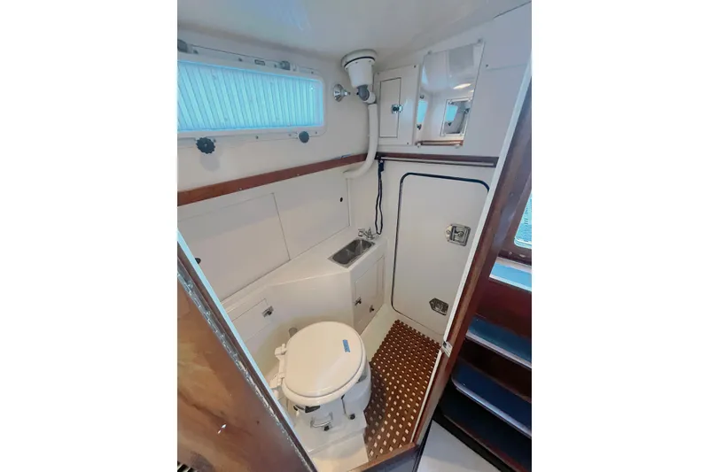 Slide: The Image of Compact boat bathroom with toilet, sink, and storage in a 2005 Brewer Cutter. - 14
