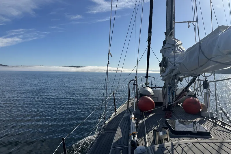Slide: The Image of Sailing on a 2005 Brewer Cutter yacht in calm waters under a clear blue sky. - 64