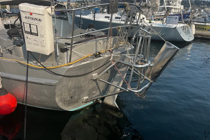 Slide: The Image of Sailboat stern with safety equipment, docked in marina, Brewer Cutter 2005 model. - 31