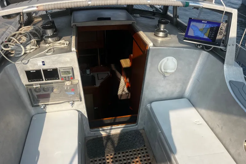 Slide: The Image of Cockpit of a 2005 Brewer Cutter sailboat with navigation equipment and seating. - 57