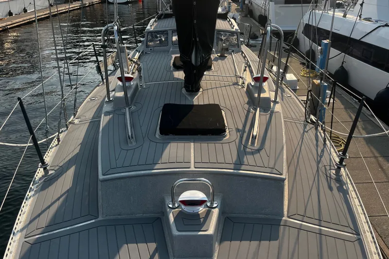 Slide: The Image of Deck view of a 2005 Brewer Cutter sailboat docked at a marina. - 35