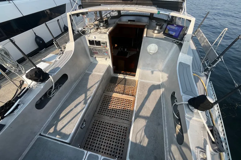 Slide: The Image of Cockpit of a 2005 Brewer Cutter sailboat with navigation equipment and open cabin door. - 53