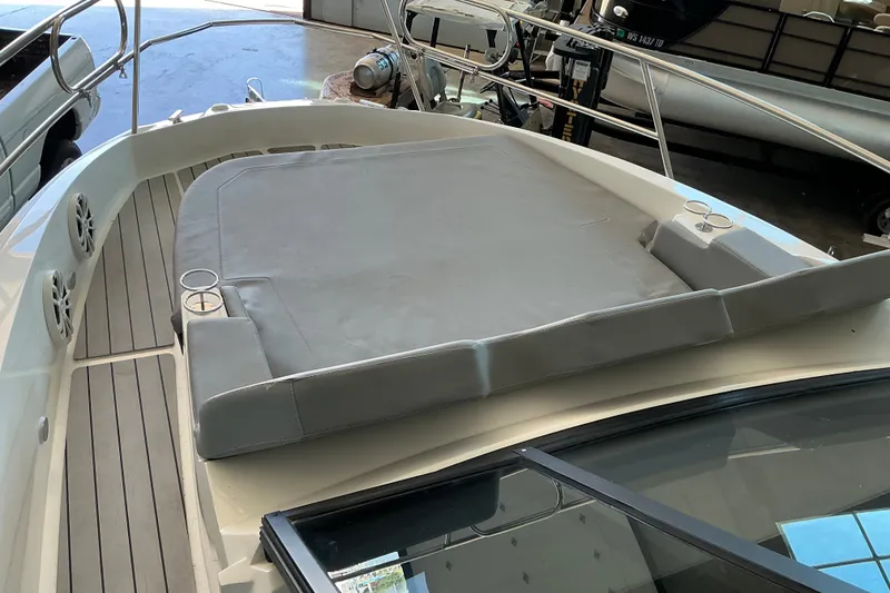 Slide: The Image of 2026 NX Boats 360 Sport Coupe deck with cushioned seating and cup holders. - 24