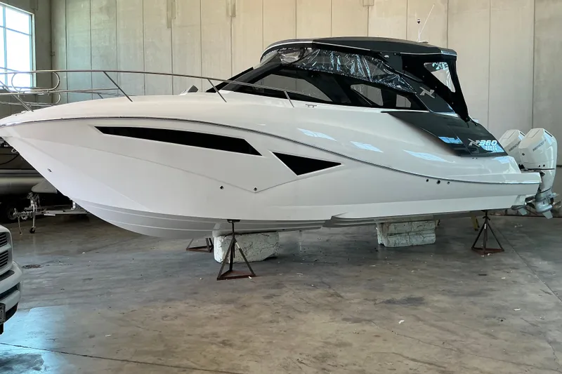 Slide: The Image of 2026 NX Boats 360 Sport Coupe in a showroom, showcasing sleek design and modern features. - 10