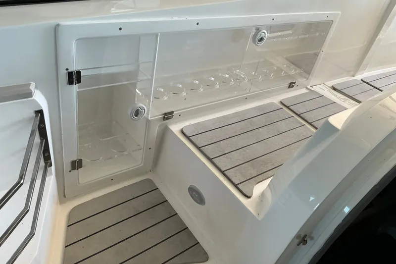 Slide: The Image of 2026 NX Boats 360 Sport Coupe interior with sleek storage compartments and modern flooring. - 23