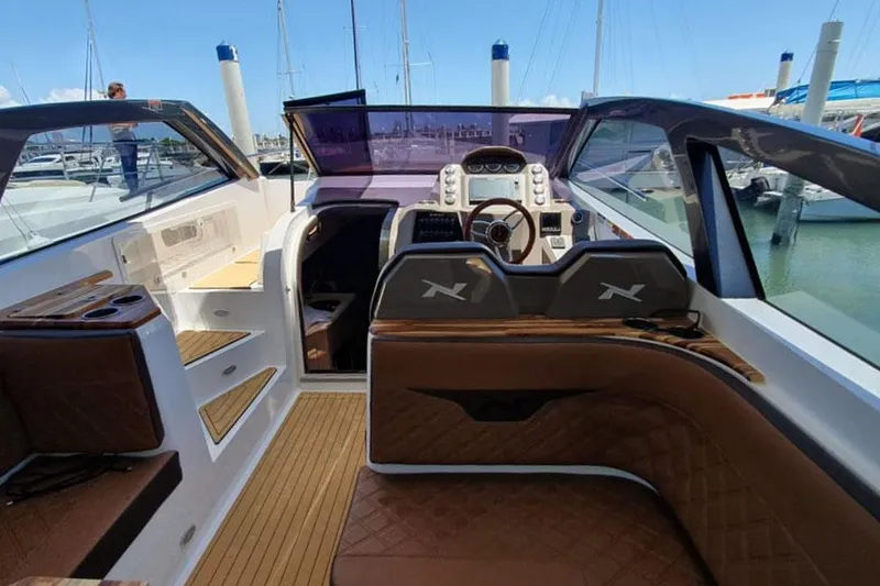 Slide: The Image of Manufacturer Provided Image: 2025 NX Boats 360 Sport Coupe interior with luxurious seating and modern dashboard. - 6