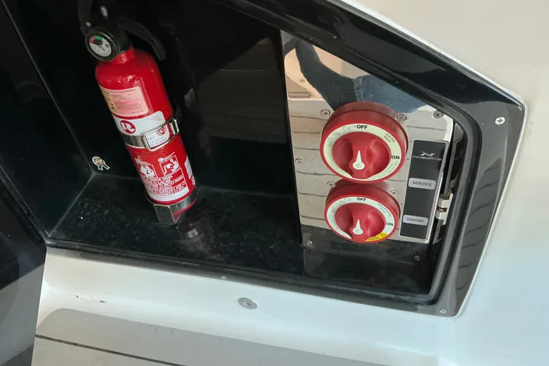 Slide: The Image of Fire extinguisher and control panel on 2026 NX Boats 360 Sport Coupe. - 15