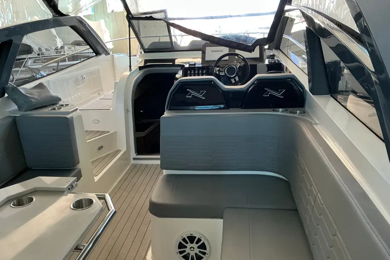 Slide: The Image of 2026 NX Boats 360 Sport Coupe interior with modern helm and seating area. - 17