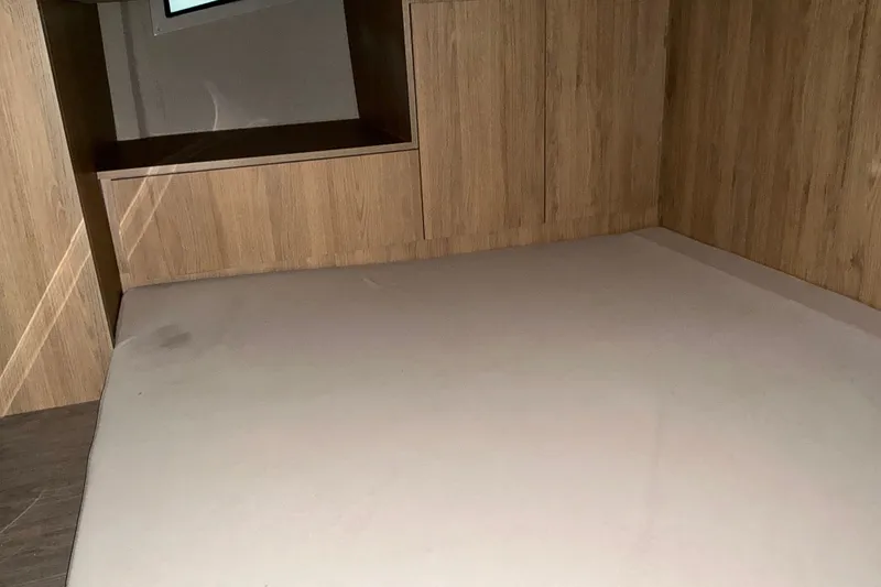 Slide: The Image of Interior cabin of 2026 NX Boats 360 Sport Coupe with wooden finish and cushioned seating. - 33