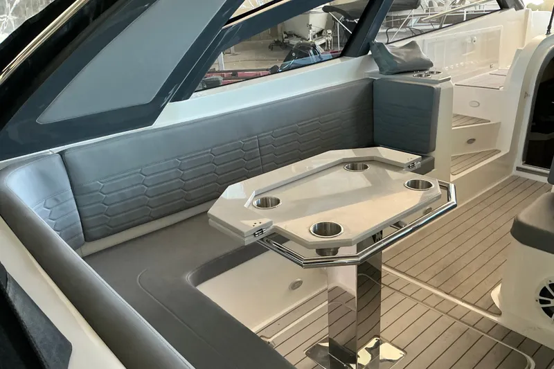 Slide: The Image of Luxurious interior of 2026 NX Boats 360 Sport Coupe with sleek seating and modern table design. - 16