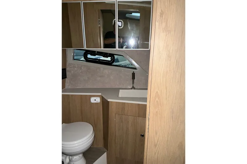 Slide: The Image of 2026 NX Boats 360 Sport Coupe bathroom with modern fixtures and wood accents. - 35