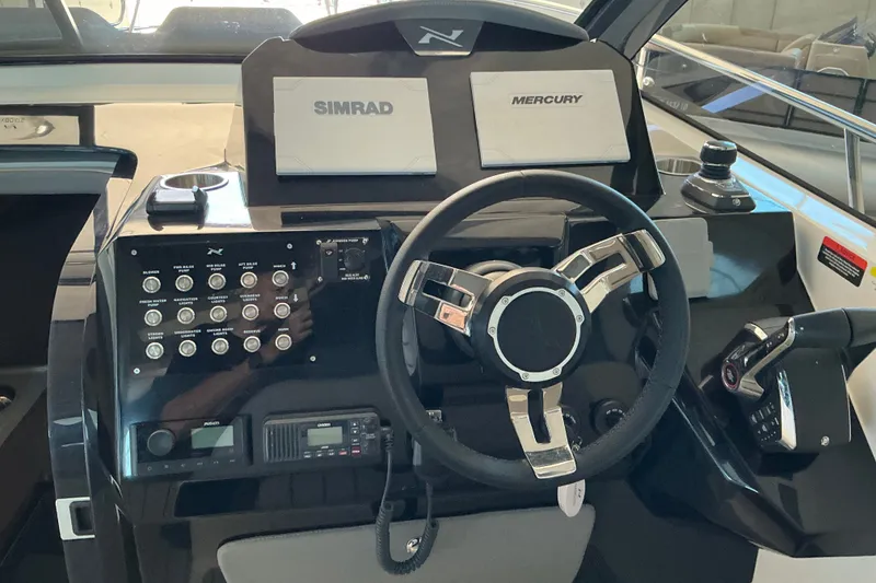Slide: The Image of 2026 NX Boats 360 Sport Coupe dashboard with steering wheel and control panels. - 20