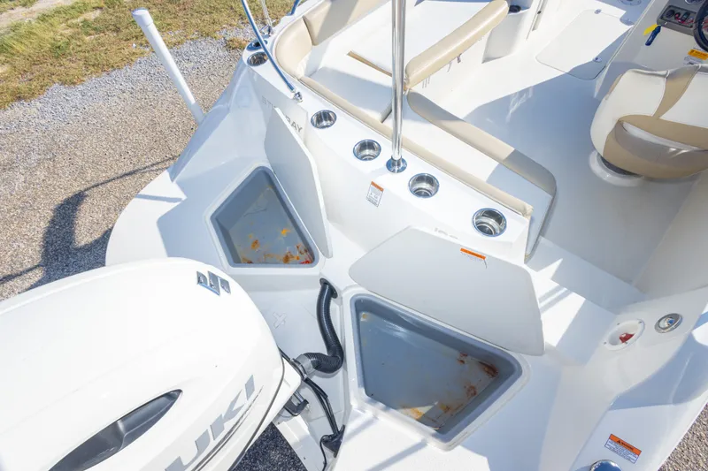 Slide: The Image of 2018 Stingray 192 SC boat interior with Suzuki engine, featuring seating and storage compartments. - 42