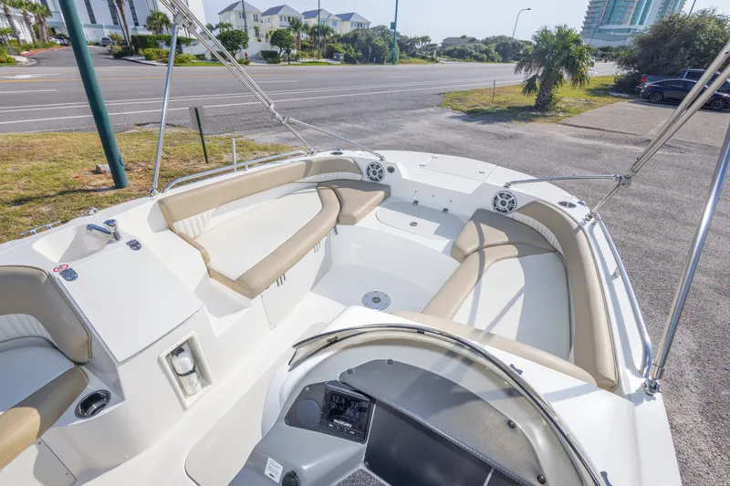 Slide: The Image of 2018 Stingray 192 SC boat interior with beige seating and modern dashboard. - 24