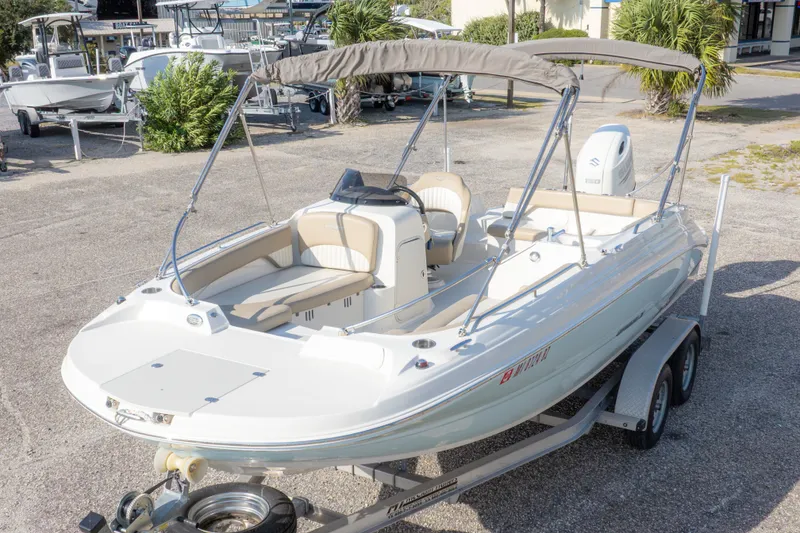 Slide: The Image of 2018 Stingray 192 SC boat on trailer, featuring spacious seating and canopy. - 4