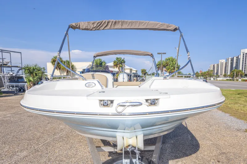Slide: The Image of 2018 Stingray 192 SC boat on trailer, sunny day, urban background. - 19