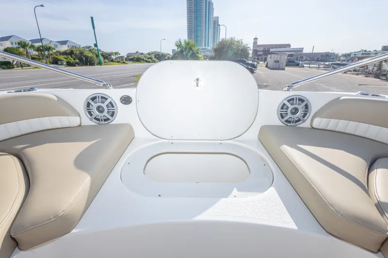 Slide: The Image of 2018 Stingray 192 SC boat interior with beige seating and built-in speakers. - 32