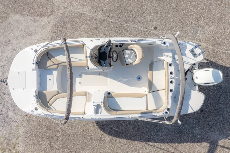 Slide: The Image of 2018 Stingray 192 SC boat, aerial view, showcasing seating and helm layout. - 6