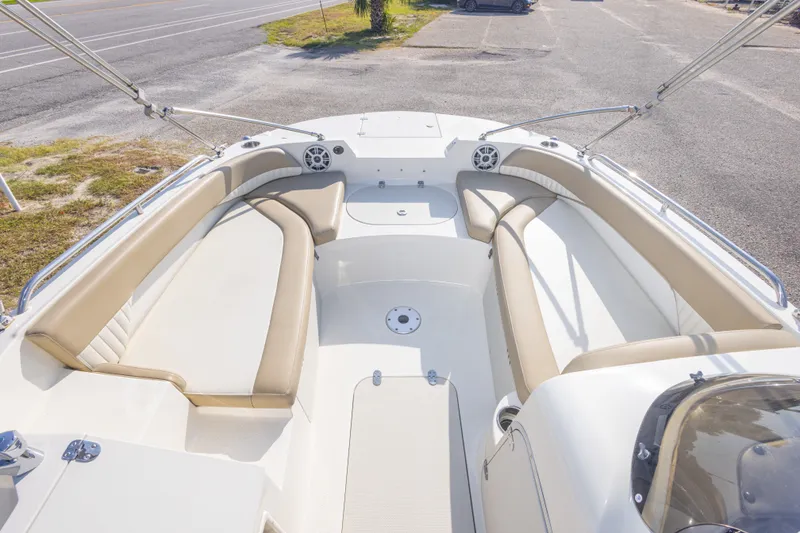 Slide: The Image of 2018 Stingray 192 SC boat interior with beige seating and open deck layout. - 26
