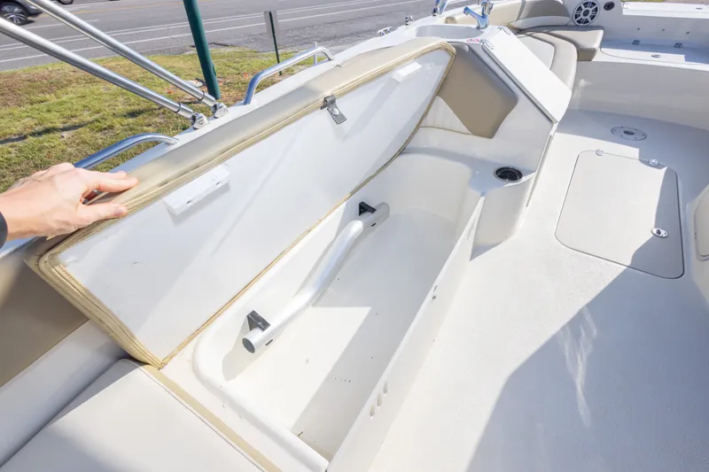 Slide: The Image of 2018 Stingray 192 SC boat interior with open storage compartment and seating area. - 39