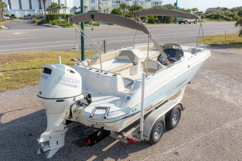Slide: The Image of 2018 Stingray 192 SC boat with Suzuki outboard motor on a trailer. - 46