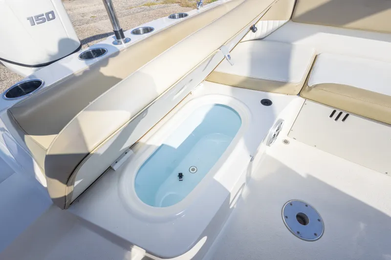 Slide: The Image of 2018 Stingray 192 SC boat interior with seating and built-in storage compartment. - 38