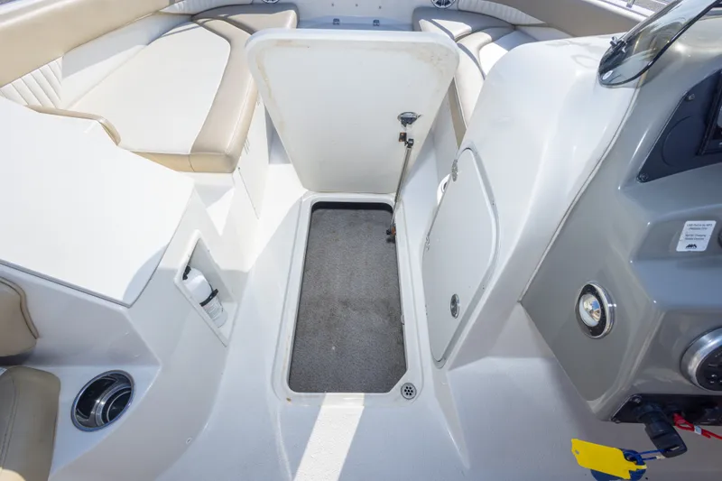 Slide: The Image of 2018 Stingray 192 SC boat interior with open storage compartment and seating. - 35