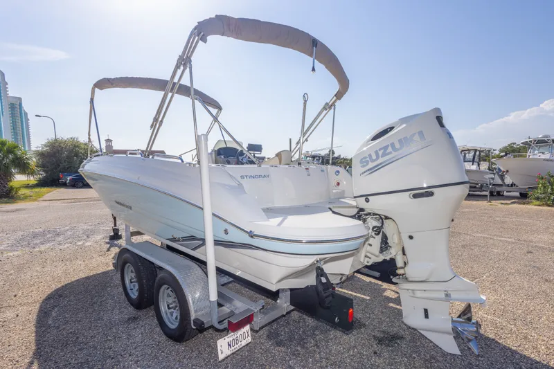 Slide: The Image of 2018 Stingray 192 SC boat with Suzuki outboard motor on trailer. - 16